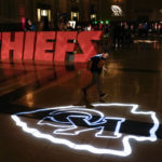 
              A boy runs across a logo for the Kansas City Chiefs NFL football team while attending a display Thursday, Feb. 9, 2023, at Union Station in Kansas City, Mo. The Chiefs are scheduled to play the Philadelphia Eagles in Super Bowl LVII on Sunday, Feb. 12, 2023. (AP Photo/Charlie Riedel)
            