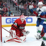 
              Detroit Red Wings goaltender Ville Husso (35) deflects a shot as Vancouver Canucks right wing Brock Boeser (6) looks for a rebound in the first period of an NHL hockey game Saturday, Feb. 11, 2023, in Detroit. (AP Photo/Paul Sancya)
            