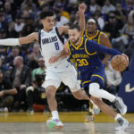 
              Golden State Warriors guard Stephen Curry (30) brings the ball up the court against Dallas Mavericks guard Josh Green (8) during the second half of an NBA basketball game in San Francisco, Saturday, Feb. 4, 2023. (AP Photo/Jeff Chiu)
            