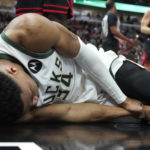 
              Milwaukee Bucks' Giannis Antetokounmpo lies by the basket after injuring his right wrist during the first half of the team's NBA basketball game against the Chicago Bulls on Thursday, Feb. 16, 2023, in Chicago. (AP Photo/Charles Rex Arbogast)
            