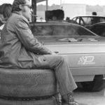 
              FILE -Stock car racer Richard Petty, of Randleman, N.C., sits on a stack of tires, smoking a cigar, while his crew prepares his 1972 Plymouth for a practice run before qualifying Saturday, Feb. 12, 1972, for the Daytona 500,  at Daytona International Speedway in Daytona, Fla. NASCAR’s next 75 years almost certainly will include at least a partially electric vehicle turning laps at Daytona International Speedway. It’s unfathomable to some, unconscionable to others. . (AP Photo/James P. Kerlin, File)
            