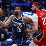 
              Dallas Mavericks guard Spencer Dinwiddie (26) battles New Orleans Pelicans forward Larry Nance Jr. (22) for space during the second half of an NBA basketball game, Thursday, Feb. 2, 2023, in Dallas. (AP Photo/Brandon Wade)
            
