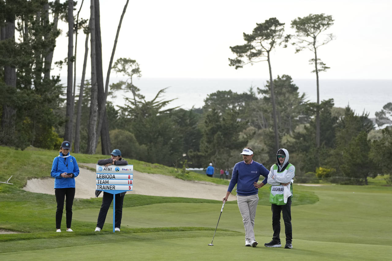 Hank Lebioda, second from right, waits to putt on the 18th green of the Monterey Peninsula Country ...