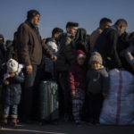 
              Syrians stand in a queue as they wait to return to their country from the Turkish crossing point of Cilvegozu, in Reyhanli, southeastern Turkey, Saturday, Feb. 18, 2023. A 7.8 magnitude earthquake with its epicenter in Turkey's southeastern Kharamanmaras province struck in the early hours of Feb. 6, followed by multiple aftershocks, including a major one magnitude 7.5 nine hours after the first tremor. (AP Photo/Bernat Armangue)
            