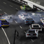 
              NASCAR Cup Series driver Michael McDowell (34) crashes during a NASCAR exhibition auto race at Los Angeles Memorial Coliseum, Sunday, Feb. 5, 2023, in Los Angeles. (AP Photo/Ashley Landis)
            
