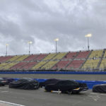 
              Covered race cars from the NASCAR Xfinity Series sit parked on pit road during a rain delay before the start of the race in Fontana, Calif., Saturday, Feb. 25, 2023. NASCAR has canceled practice and qualifying sessions for the weekend races at Fontana because of ongoing heavy rains. (AP Photo/Greg Beacham)
            