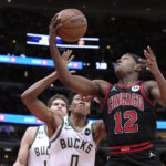 
              Chicago Bulls' Ayo Dosunmu (12) drives to the basket as Milwaukee Bucks' MarJon Beauchamp defends during the first half of an NBA basketball game Thursday, Feb. 16, 2023, in Chicago. (AP Photo/Charles Rex Arbogast)
            