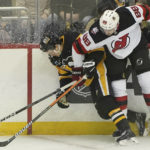 
              New Jersey Devils defenseman Kevin Bahl (88) checks Pittsburgh Penguins right wing Josh Archibald (15) into the boards during the first period of an NHL hockey game in Pittsburgh, Saturday, Feb. 18, 2023. (AP Photo/Matt Freed)
            