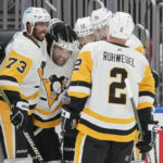 
              Pittsburgh Penguins left wing Jason Zucker, second from left, is congratulated for his goal against the New York Islanders during the second period of an NHL hockey game Friday, Feb. 17, 2023, in Elmont, N.Y. (AP Photo/Mary Altaffer)
            