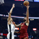 
              Cleveland Cavaliers guard Ricky Rubio (13) shoots against San Antonio Spurs forward Jeremy Sochan (10) during the first half of an NBA basketball game, Monday, Feb. 13, 2023, in Cleveland. (AP Photo/Ron Schwane)
            