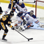 
              Pittsburgh Penguins defenseman Kris Letang (58) shoots and scores on Edmonton Oilers goalie Stuart Skinner (74) during the first period of an NHL hockey game, Thursday, Feb. 23, 2023, in Pittsburgh. (AP Photo/Philip G. Pavely)
            