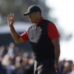 
              Tiger Woods waves to the gallery on the third green during the final round of the Genesis Invitational golf tournament at Riviera Country Club, Sunday, Feb. 19, 2023, in the Pacific Palisades area of Los Angeles. (AP Photo/Ryan Kang)
            