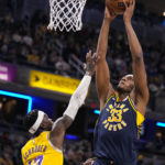 
              Indiana Pacers center Myles Turner (33) shoots over Los Angeles Lakers guard Dennis Schroder (17) during the second half of an NBA basketball game in Indianapolis, Thursday, Feb. 2, 2023. The Lakers defeated the Pacers 112-111. (AP Photo/Michael Conroy)
            