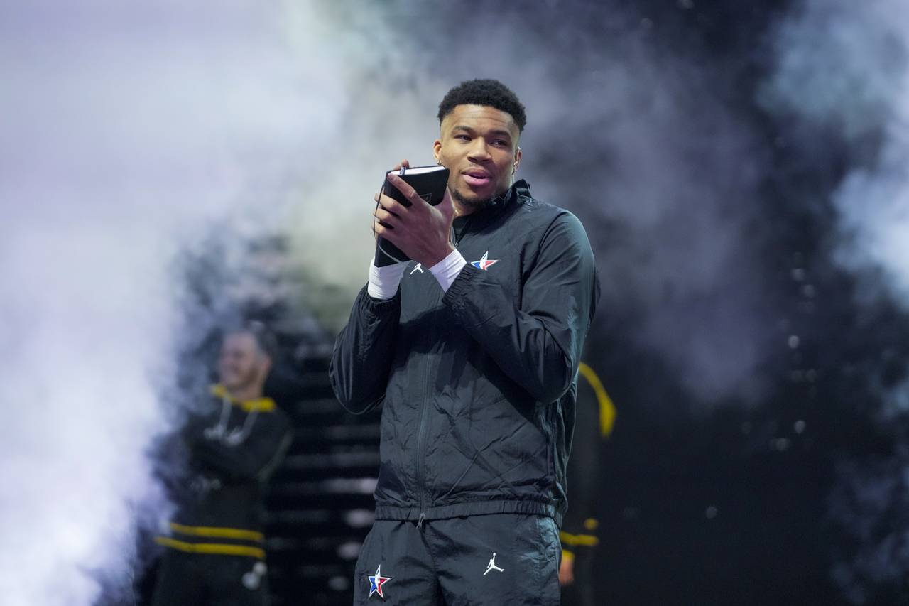Giannis Antetokounmpo smiles as he picks his team before the NBA basketball All-Star game Sunday, F...