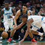 
              Charlotte Hornets' Dennis Smith Jr., right, and Boston Celtics' Malcolm Brogdon (13) try to get possession of the ball during the first half of an NBA basketball game Friday, Feb. 10, 2023, in Boston. (AP Photo/Michael Dwyer)
            
