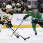 
              Boston Bruins left wing Taylor Hall (71) controls the puck under pressure from Dallas Stars center Radek Faksa, rear, in the first period of an NHL hockey game, Tuesday, Feb. 14, 2023, in Dallas. (AP Photo/Tony Gutierrez)
            