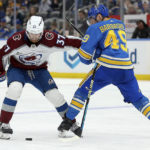
              Colorado Avalanche's J.T. Compher (37) and St. Louis Blues' Ivan Barbashev (49) vie for a loose puck during the third period of an NHL hockey game Saturday, Feb. 18, 2023, in St. Louis. (AP Photo/Scott Kane)
            