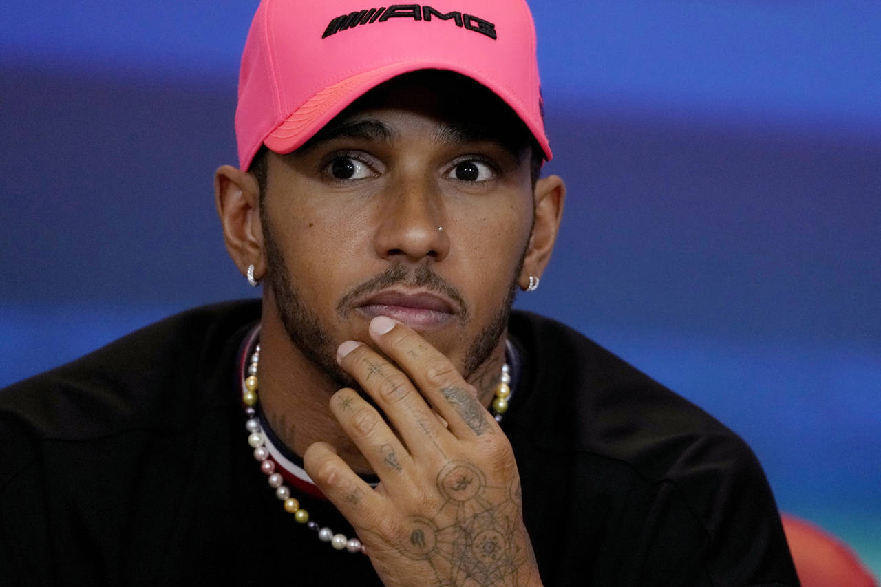 FILE - Lewis Hamilton of Great Britain and Mercedes reacts in a press conference during previews ah...