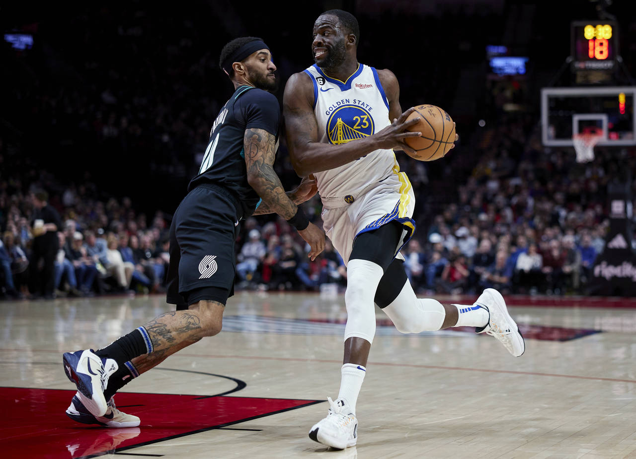 Golden State Warriors forward Draymond Green drives to the basket past Portland Trail Blazers guard...