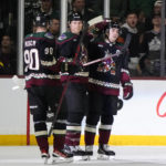 
              Arizona Coyotes defenseman Jakob Chychrun (6) celebrates with defenseman J.J. Moser (90) and right wing Clayton Keller after scoring a goal against the Minnesota Wild in the second period during an NHL hockey game, Monday, Feb. 6, 2023, in Tempe, Ariz. (AP Photo/Rick Scuteri)
            