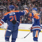 
              Edmonton Oilers' Connor McDavid (97) and Klim Kostin (21) celebrate after McDavid's 50th goal of the season during second-period NHL hockey game action against the Boston Bruins in Edmonton, Alberta, Monday, Feb. 27, 2023. (Jason Franson/The Canadian Press via AP)
            