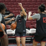 
              UNLV NCAA college basketball guard Essence Booker, center, wipes sweat from her brow during practice Wednesday, Feb. 15, 2023, in Las Vegas. This season the Lady Rebels are repeat Mountain West champions and ranked at No. 24 in the AP poll for the first time in 29 years.(AP Photo/John Locher)
            