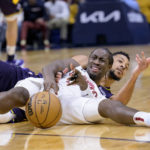 
              Cleveland Cavaliers guard Caris LeVert, left, and New Orleans Pelicans guard CJ McCollum, right, battle for the ball in the first half of an NBA basketball game in New Orleans, Friday, Feb. 10, 2023. (AP Photo/Matthew Hinton)
            