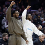 
              Injured Cleveland Cavaliers guards Donovan Mitchell, left, and Darius Garland cheer from the bench during the first half of an NBA basketball game against the Detroit Pistons, Wednesday, Feb. 8, 2023, in Cleveland. (AP Photo/Ron Schwane)
            