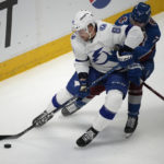 
              Tampa Bay Lightning defenseman Erik Cernak, left, fights for control of the puck with Colorado Avalanche defenseman Devon Toews in the first period of an NHL hockey game, Tuesday, Feb. 14, 2023, in Denver. (AP Photo/David Zalubowski)
            