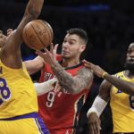 
              New Orleans Pelicans center Willy Hernangomez, center, goes after a loose ball along with Los Angeles Lakers forward Rui Hachimura, left and forward LeBron James during the first half of an NBA basketball game Wednesday, Feb. 15, 2023, in Los Angeles. (AP Photo/Mark J. Terrill)
            