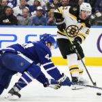 
              Boston Bruins' Brad Marchand (63) passes past Toronto Maple Leafs' Morgan Rielly (44) during the third period of an NHL hockey game, Wednesday, Feb.1, 2023 in Toronto. (Frank Gunn/The Canadian Press via AP)
            