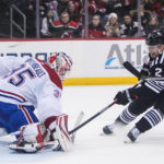 
              Montreal Canadiens goaltender Sam Montembeault (35) stops a shot on goal by New Jersey Devils' Brendan Smith (2) during the second period of an NHL hockey game Tuesday, Feb. 21, 2023, in Newark, N.J. (AP Photo/Frank Franklin II)
            