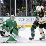 
              Dallas Stars goaltender Jake Oettinger (29) prepares to block a shot under pressure from Boston Bruins left wing Nick Foligno (17) in the second period of an NHL hockey game, Tuesday, Feb. 14, 2023, in Dallas. The Stars Esa Lindell, right rear, helps defend on the play. (AP Photo/Tony Gutierrez)
            