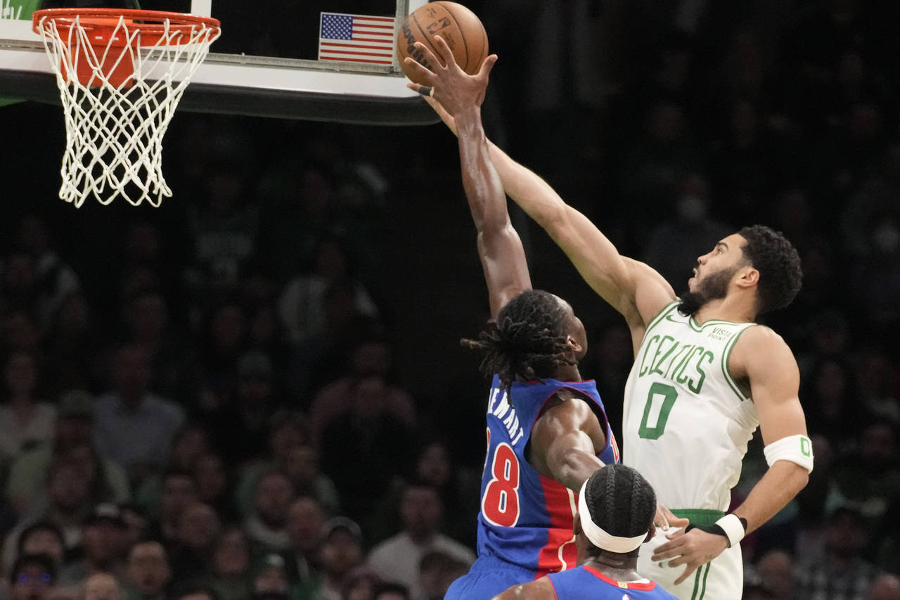 Boston Celtics forward Jayson Tatum (0) drives to the basket against Detroit Pistons center Isaiah ...