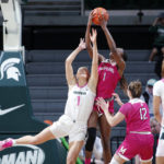 
              Michigan State's Tory Ozment, left, and Maryland's Diamond Miller reach for a rebound as Maryland's Elisa Pinzan (12) and Michigan State's DeeDee Hagemann (0) watch during the second half of an NCAA college basketball game, Saturday, Feb. 18, 2023, in East Lansing, Mich. (AP Photo/Al Goldis)
            