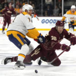 
              Arizona Coyotes right wing Christian Fischer (36) is checked by Nashville Predators defenseman Jeremy Lauzon while making a pass in the first period during an NHL hockey game, Sunday, Feb. 26, 2023, in Tempe, Ariz. (AP Photo/Rick Scuteri)
            
