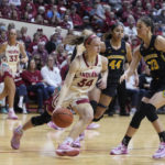 
              Indiana's Grace Berger (34) goes to the basket against Michigan's Emily Kiser (33) during the second half of an NCAA college basketball game Thursday, Feb. 16, 2023, in Bloomington, Ind. (AP Photo/Darron Cummings)
            