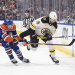 
              Boston Bruins' Pavel Zacha (18) and Edmonton Oilers' Leon Draisaitl (29) battle for the puck during first-period NHL hockey game action in Edmonton, Alberta, Monday, Feb. 27, 2023. (Jason Franson/The Canadian Press via AP)
            