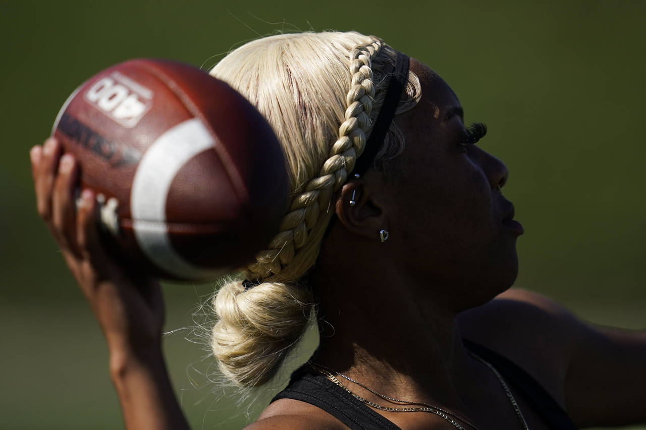 FILE - Sa'Mir Braccey, 17, throws a pass as she tries out for the Redondo Union High School girls f...
