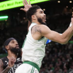 
              Boston Celtics forward Jayson Tatum, right, drives to the basket against Brooklyn Nets forward Royce O'Neale during the first half of an NBA basketball game, Wednesday, Feb. 1, 2023, in Boston. (AP Photo/Charles Krupa)
            
