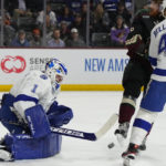 
              Tampa Bay Lightning goaltender Brian Elliott (1) makes the save in front of left wing Pierre-Edouard Bellemare and Arizona Coyotes center Nick Schmaltz (8) in the first period during an NHL hockey game, Wednesday, Feb. 15, 2023, in Tempe, Ariz. (AP Photo/Rick Scuteri)
            
