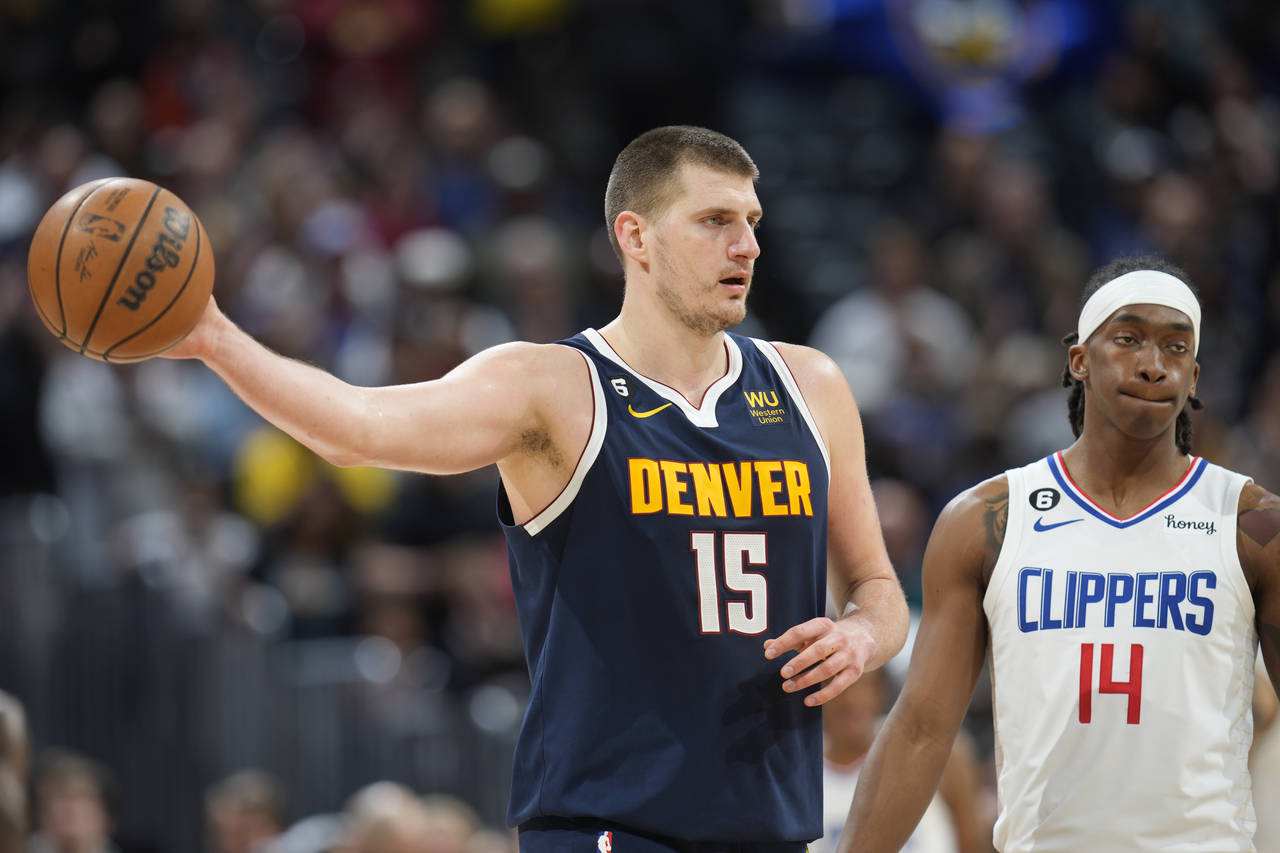 Denver Nuggets center Nikola Jokic holds on to the ball as time runs out in overtime of an NBA bask...