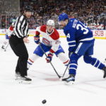 
              Toronto Maple Leafs forward Auston Matthews (34) and Montreal Canadiens forward Christian Dvorak (28) face off during first-period NHL hockey game action in Toronto, Saturday, Feb. 18, 2023. (Christopher Katsarov/The Canadian Press via AP)
            