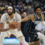
              Los Angeles Lakers forward Anthony Davis, left, intercepts a pass meant for Dallas Mavericks forward Christian Wood, right, during the fourth quarter of an NBA basketball game in Dallas, Sunday, Feb. 26, 2023. (AP Photo/LM Otero)
            