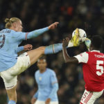 
              Manchester City's Erling Haaland, left, challenges for the ball with Arsenal's Thomas Partey during the English FA Cup 4th round soccer match between Manchester City and Arsenal at the Etihad Stadium in Manchester, England, Friday, Jan. 27, 2023. (AP Photo/Dave Thompson)
            