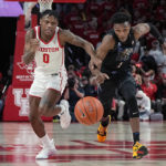 
              Houston guard Marcus Sasser (0) and Memphis guard Keonte Kennedy (1) chase the ball during the first half of an NCAA college basketball game Sunday, Feb. 19, 2023, in Houston. (AP Photo/Kevin M. Cox)
            