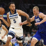
              Minnesota Timberwolves forward Kyle Anderson, left, reaches for the ball next to Los Angeles Clippers center Mason Plumlee during the first half of an NBA basketball game Tuesday, Feb. 28, 2023, in Los Angeles. (AP Photo/Marcio Jose Sanchez)
            