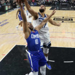 
              Minnesota Timberwolves center Rudy Gobert, top, blocks a shot from Los Angeles Clippers guard Eric Gordon (10) during the first half of an NBA basketball game Tuesday, Feb. 28, 2023, in Los Angeles. (AP Photo/Marcio Jose Sanchez)
            