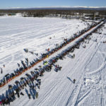 
              FILE - A competitor mushes across Willow Lake during the restart of the Iditarod Trail Sled Dog Race on March 6, 2022, in Willow, Alaska. Only 33 mushers will participate in the ceremonial start of the Iditarod Trail Sled Dog Race on Saturday, March 4, the smallest field ever. (Loren Holmes/Anchorage Daily News via AP, File)
            