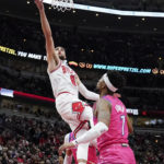 
              Chicago Bulls guard Zach LaVine, top, drives to the basket against Washington Wizards guard Jordan Goodwin during the first half of an NBA basketball game in Chicago, Sunday, Feb. 26, 2023. (AP Photo/Nam Y. Huh)
            